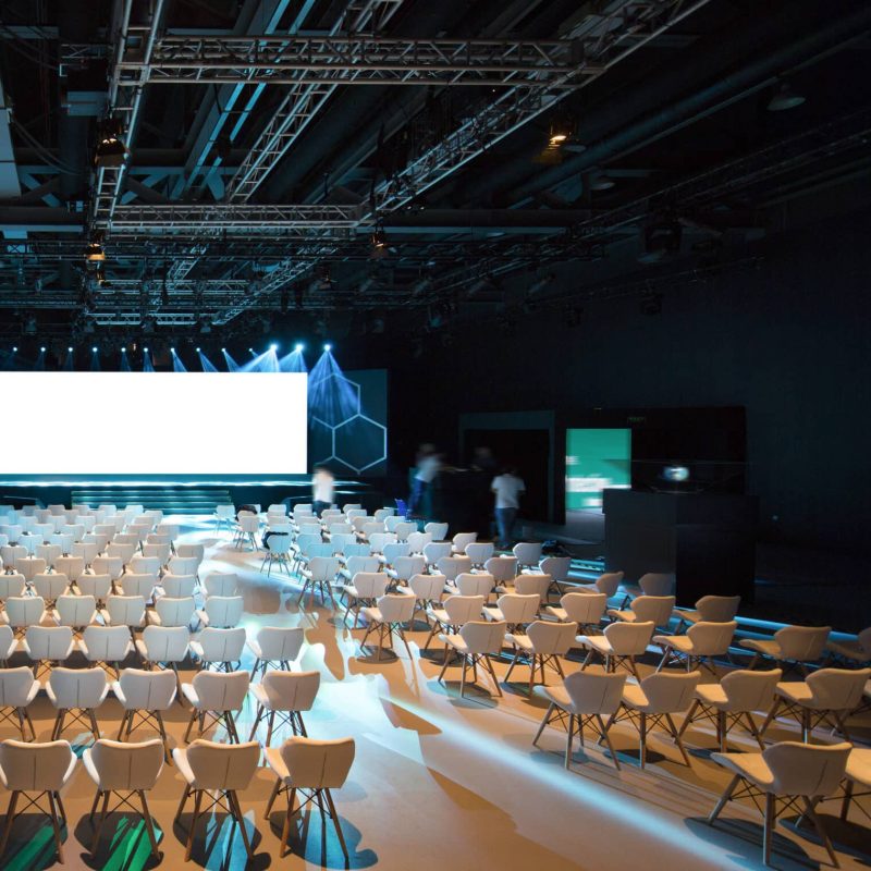 Super,Conference,Hall,With,White,Chairs,And,Colored,Illumination,And